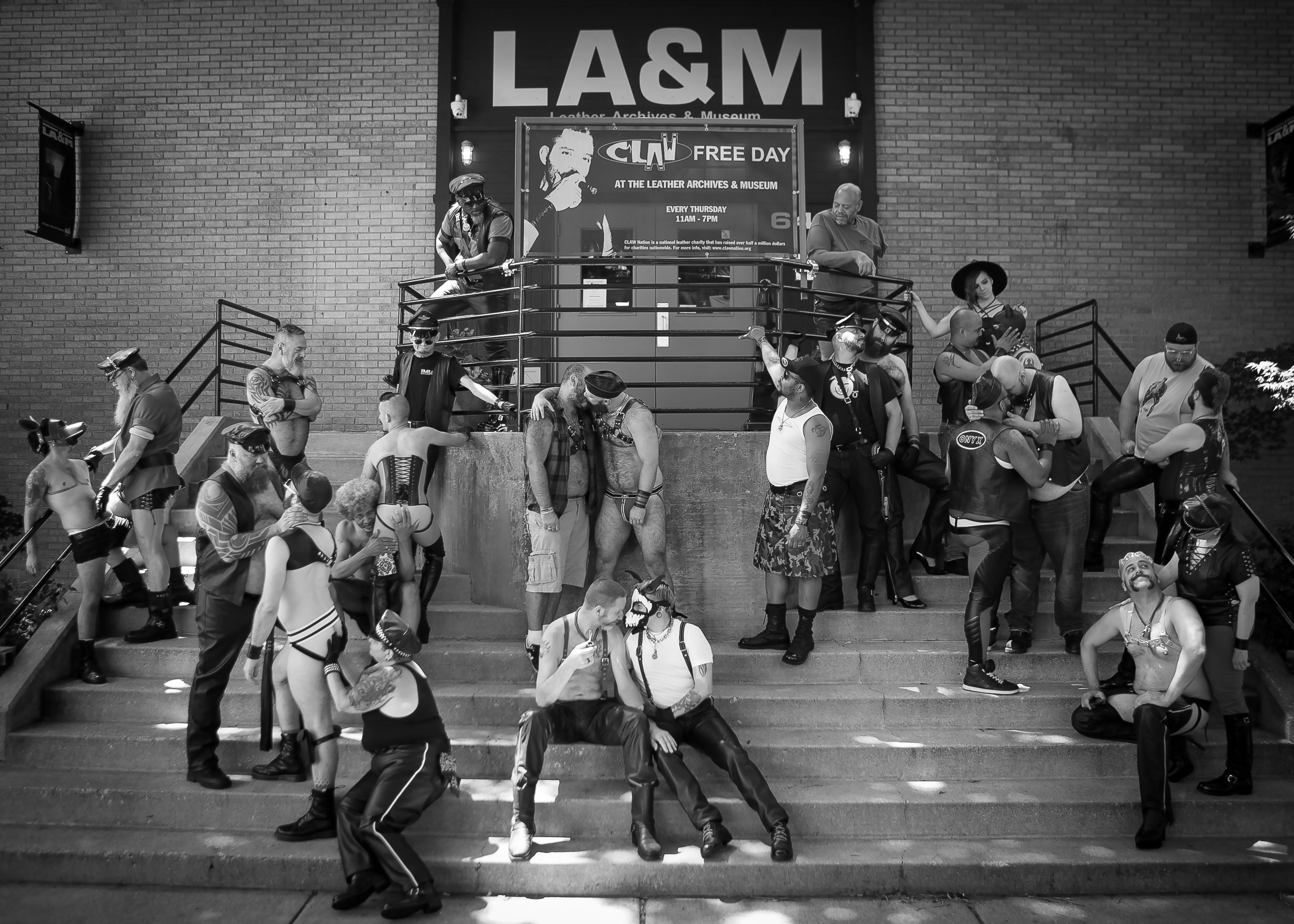 Men in leather on the front steps of the Leather Archives and Museum