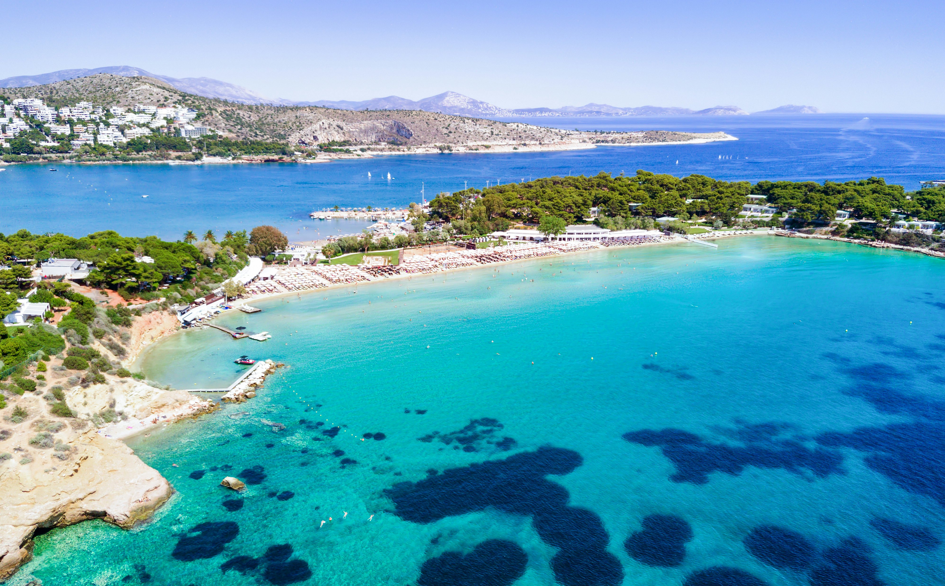 The clear blue sea lapping the curve of Astir Beach