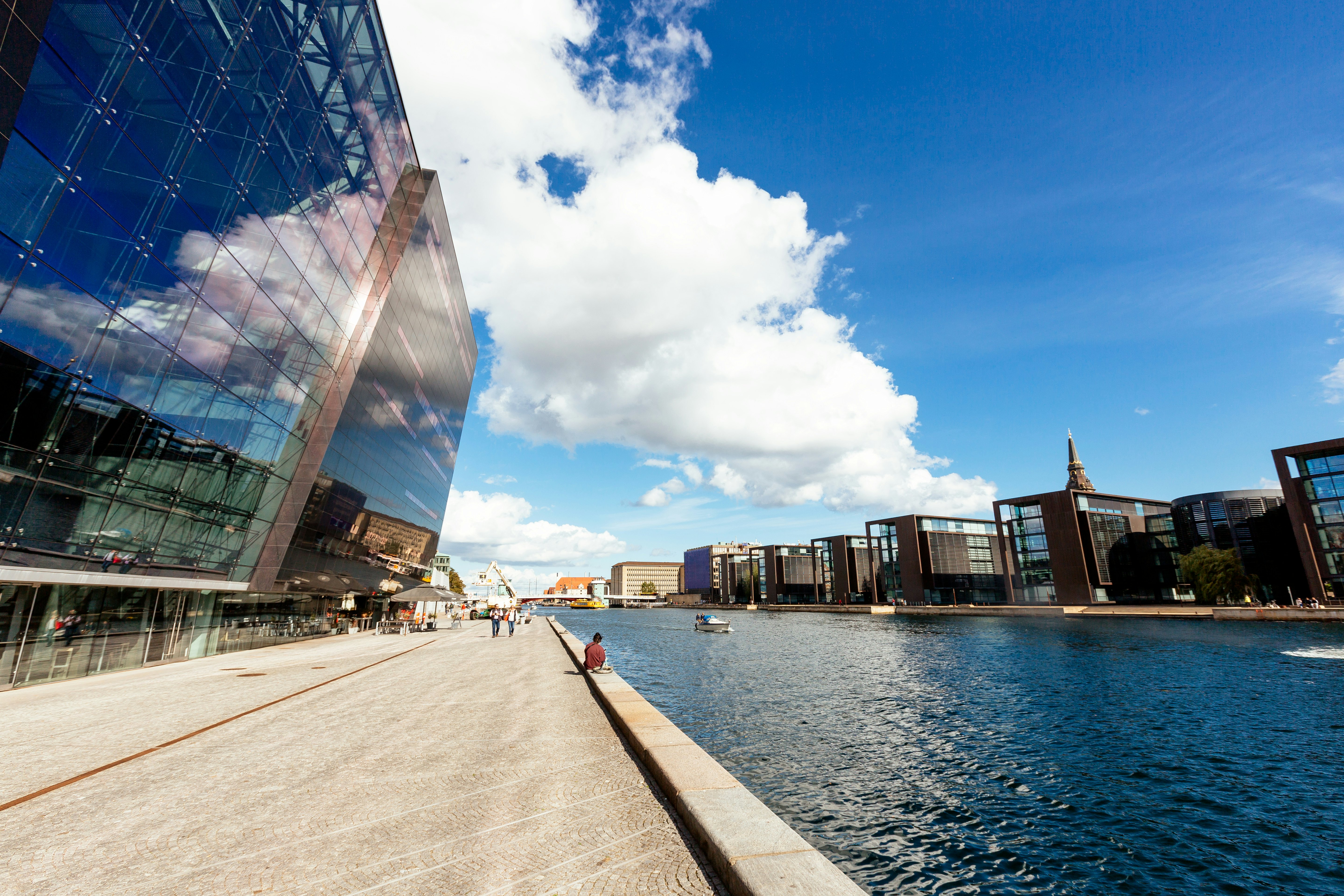 Modern glass buildings along a city waterfront