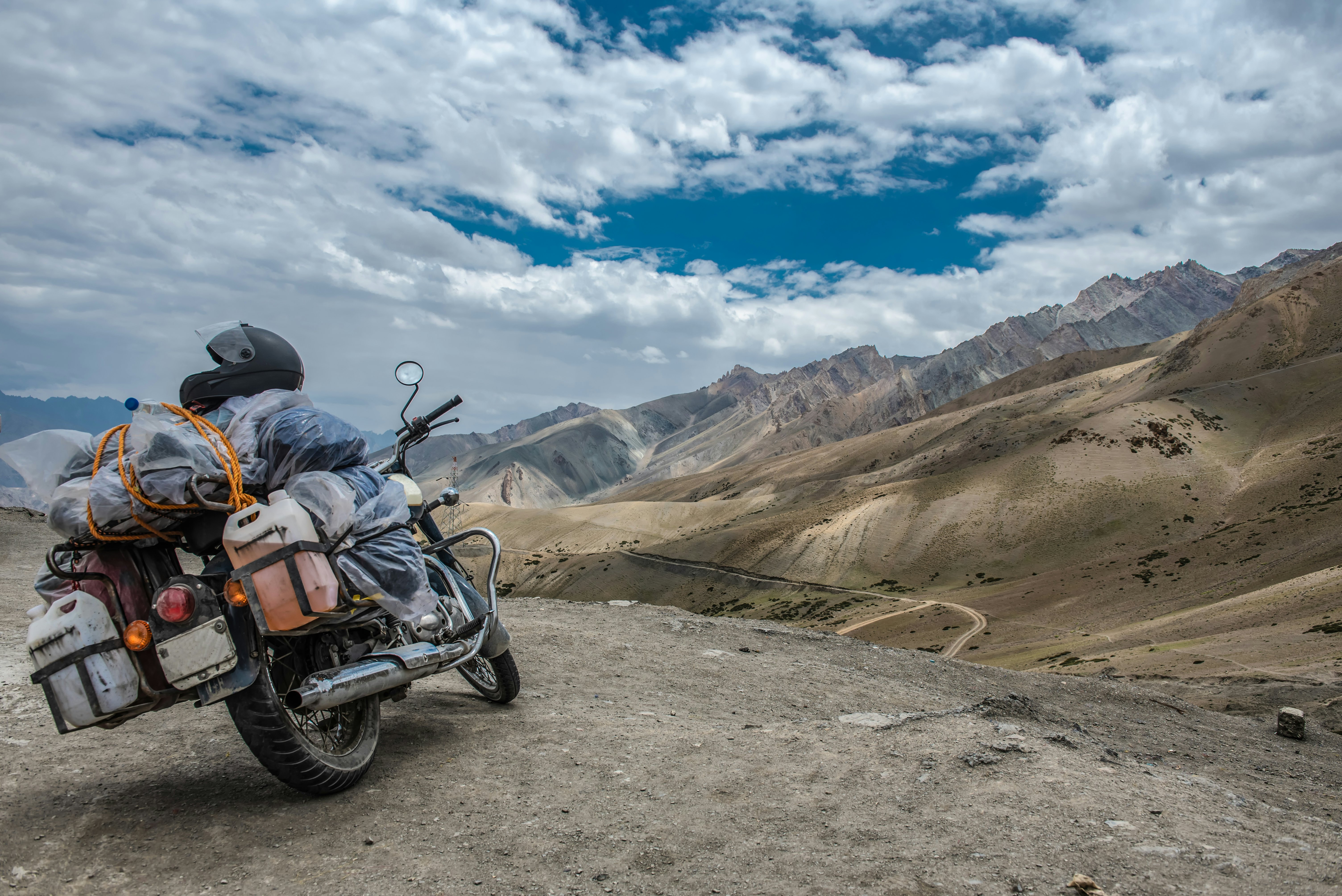 A heavily loaded motorbike in arid high-altitude mountains