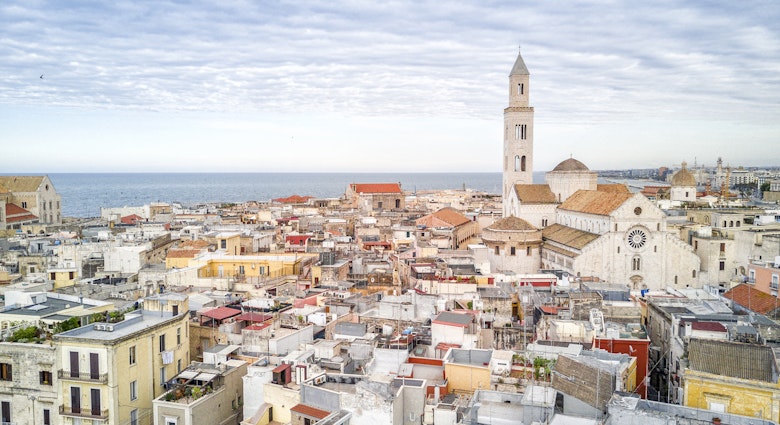 A view of the tightly packed buildings of Bari's Old Town, with Basilica di San Nicola on the right and the sea in the distance