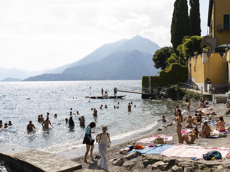 Beachgoers swimming in a lake