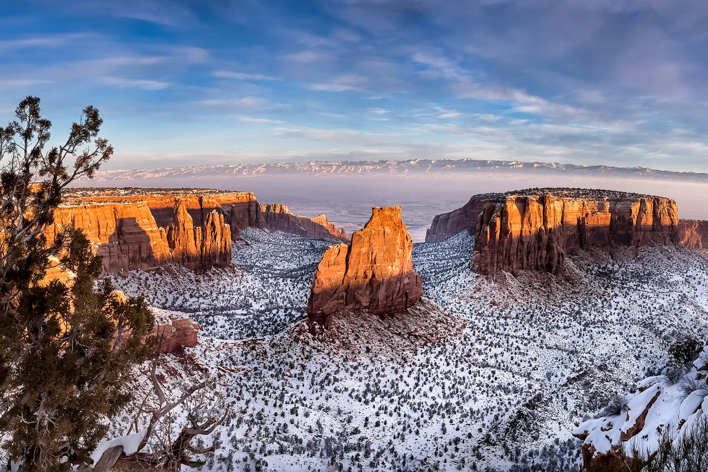 Sunshine glints off rocky outcrops in Colorado National Monument in winter.