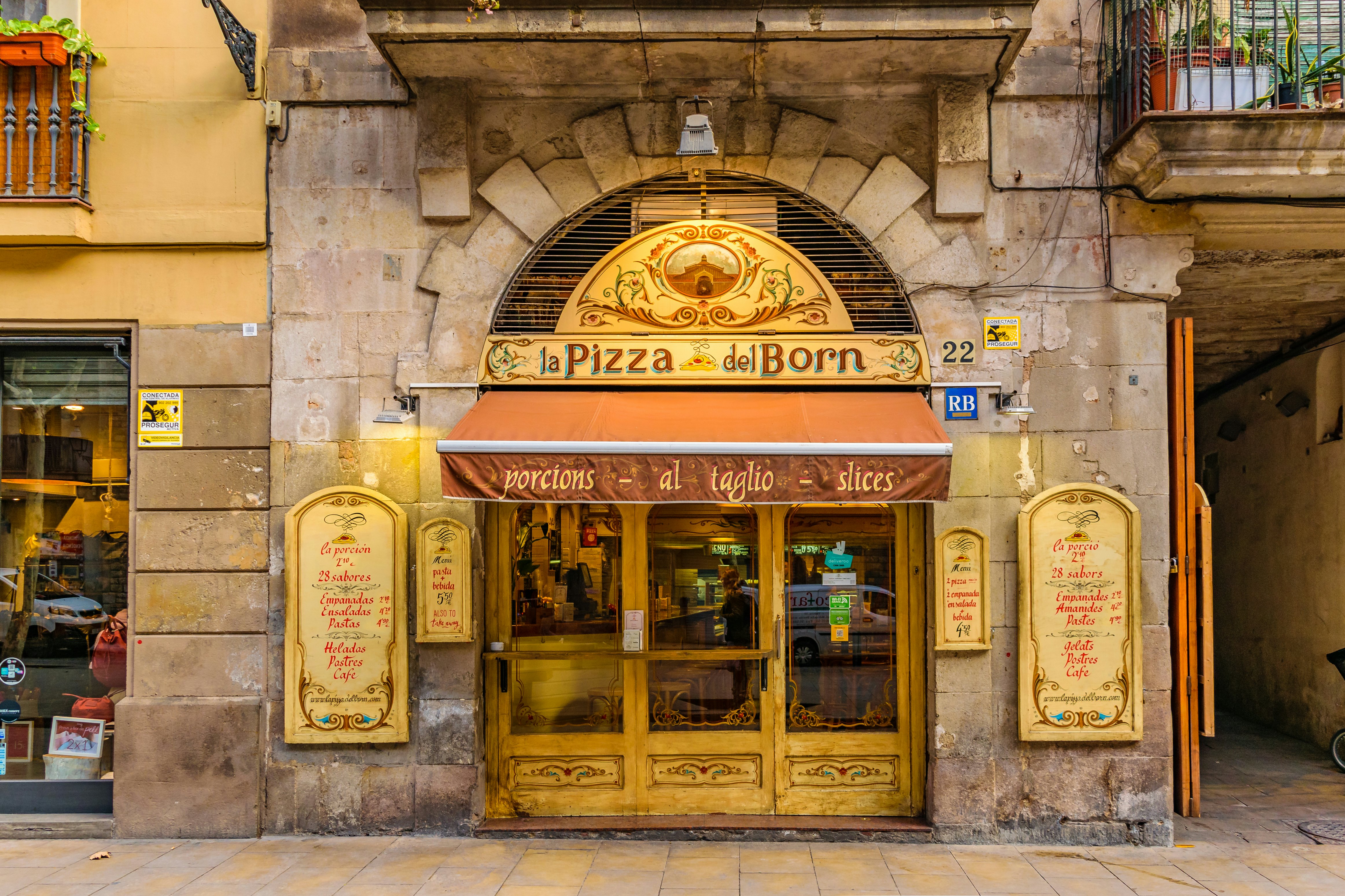 Front view picturesque antique facade pizza restaurant at Gothic district in Barcelona city Spain
