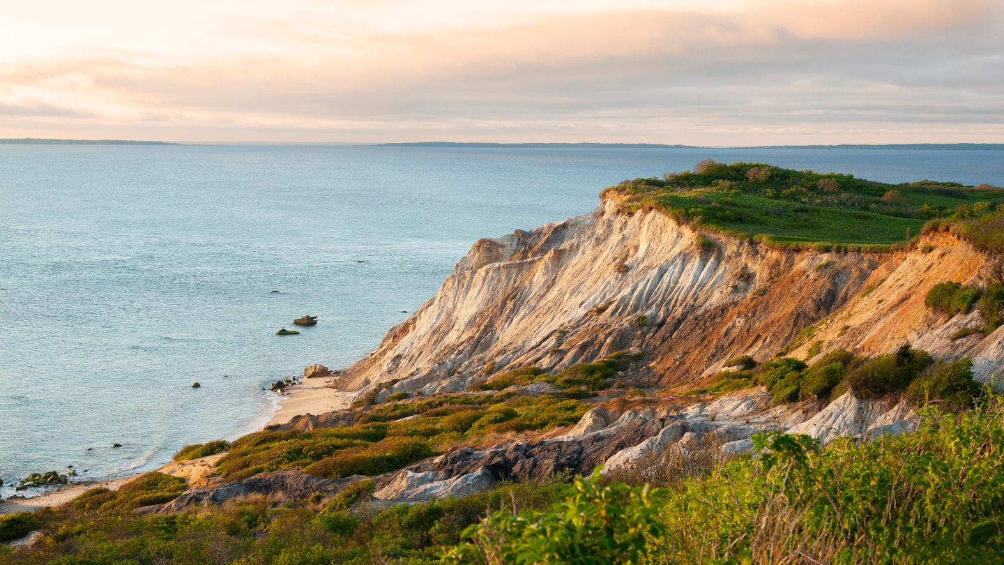 Sun sets illunimating sandy cliffs of Moshup Beach in Aquinnah, on Martha’s Vineyard island, in Massachusetts. It is a favorite attraction for tourists looking for a spiritual connection., License Type: media, Download Time: 2025-01-28T16:39:19.000Z, User: katelyn.perry_lonelyplanet, Editorial: false, purchase_order: 65050 - Digital Destinations and Articles, job: Lonely Planet WiP, client: Lonely Planet WiP, other: KP